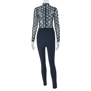 Detail of sheer mesh patchwork jumpsuit with graphic print and long sleeves