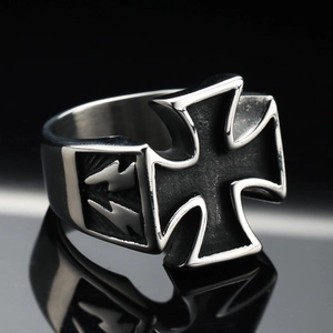 Macro detail of retro stainless steel cross ring with side lightning bolt symbols