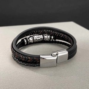 Detail view of multi-layer woven leather bracelet featuring stainless steel clasp and beads