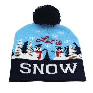 Detail of blue knitted Christmas hat with LED lights, snowflakes, and 'Let it SNOW' text