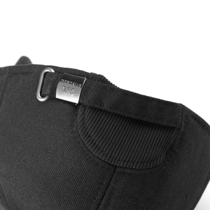 Detail of black knit baseball cap showing ribbed texture and engraved metal buckle