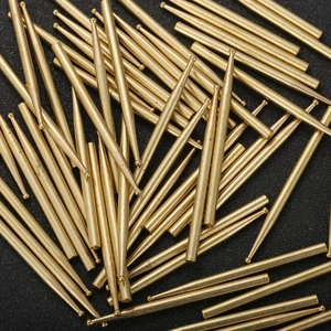 Macro shot of precision solid brass positioning pins with round heads on black background
