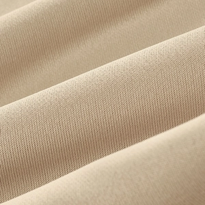 Macro shot of khaki plaid knit fabric texture showing high-density weave detail