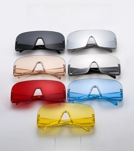 Flat lay of seven stylish visor sunglasses in assorted colors with rivet details