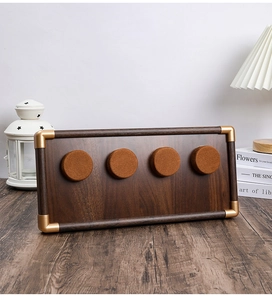 Walnut jewelry display tray with gold metal corners and four velvet circular watch slots