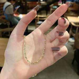 Minimalist gold chain necklace featuring half-link and half-zirconia stone design