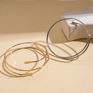 Minimalist double layer spiral cuff bracelet in polished gold and silver metal finishes