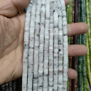 Macro shot of natural white stone spacer beads with unique black veins for DIY jewelry