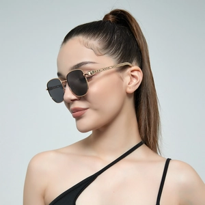 Retro small rectangular gold metal sunglasses with chain textured temples on model