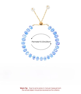 Detail view of light blue beaded bracelet with adjustable gold chain and sizing info