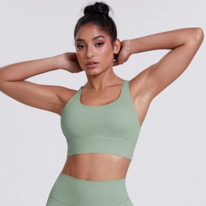 Detail view of avocado green seamless sports bra and high-waisted yoga leggings