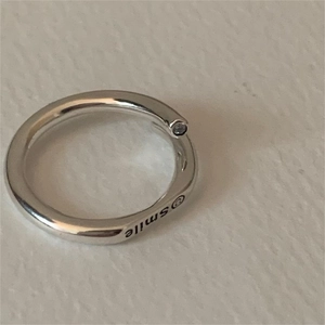 Detailed close-up of S925 sterling silver smile ring featuring engraved smiling face detail