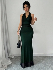 Front view of deep green floor-length mermaid dress with V-neck halter and side pleats