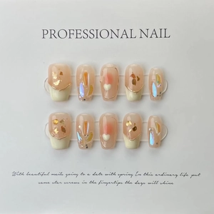 Luxurious handmade press-on nails with pink gradients, french tips and heart charms