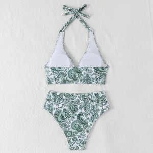 Flat lay of two-piece halter bikini featuring green paisley floral print and high waist