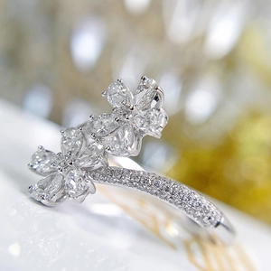 Elegant silver open ring featuring dual flower patterns with pear-cut cubic zirconia