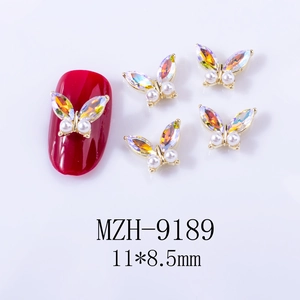 Detail of 11x8.5mm aurora butterfly nail art charm with gold base and white pearls