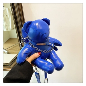 Detail of royal blue bear-shaped PU leather crossbody bag with metal chain link