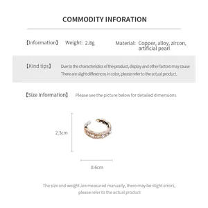 Detail shot of wavy zircon and pearl open ring with intricate hollow gold-plated copper base