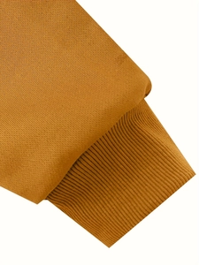 Detailed close-up of the mustard yellow ribbed cuff on a long-sleeve cotton blend sweatshirt