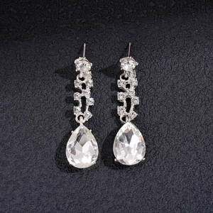 Detail view of crystal waterdrop pendant earrings with silver tassel and pear cut rhinestones