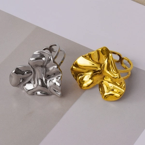 Detail of gold and silver irregular crinkled heart rings with high mirror polish finish
