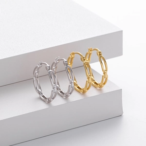 Detailed macro view of S925 sterling silver hollow chain earrings in gold and silver