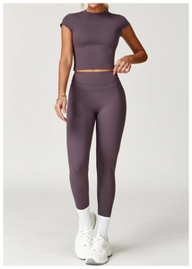 Front view of a purple high-waisted yoga set with a tight short-sleeve crop top