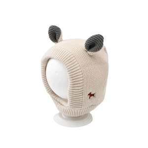 Warm beige baby knit hat with ear flaps and cute dog patch for autumn and winter