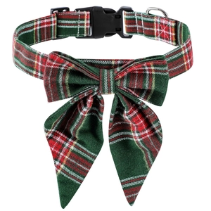Close-up of red and green tartan dog collar with festive bowtie and durable D-ring