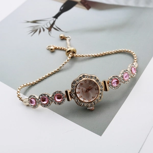 Elegant gold quartz bracelet watch with pink gemstones and floral sparkling diamond bezel