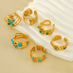 Set of 6 vintage bohemian gold rings featuring turquoise and opal stones on a wavy stand