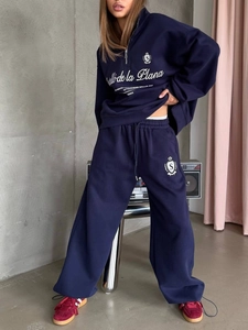 Full view of navy half-zip sweatshirt and wide-leg joggers set on a fashion model