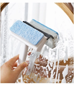 Dual-sided window squeegee cleaning foam on glass surface with sponge and rubber blade