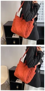 Detail of orange quilted tote bag featuring diamond stitch nylon and side pocket