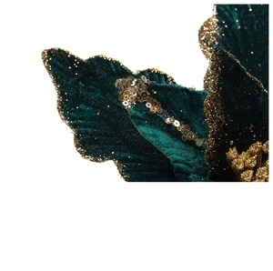 Macro view of dark green velvet Christmas flower with golden glitter and sequin details