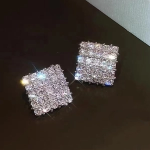 Sparkling silver geometric rhombus stud earrings with micro-pave zirconia in starburst light