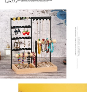 Detail view of wooden and metal jewelry organizer with tiered storage for rings and necklaces