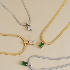 Luxe snake chain necklaces with emerald and clear zircon pendants in gold and silver