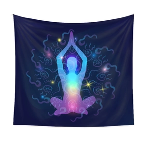 Detail of yoga meditation tapestry with rainbow nebula silhouette on dark blue fabric