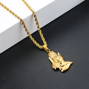 Detailed close-up of golden praying hands pendant with twisted rope chain necklace