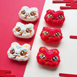 Close-up of traditional Chinese tiger head plush charms with detailed red embroidery