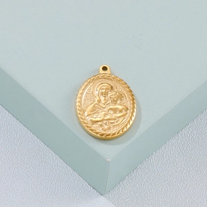 Macro detail of oval gold Virgin Mary pendant featuring embossed relief and rope edge