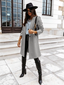 Outdoor street style shot of long grey wool coat with notch lapels and buttons