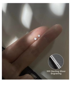 Detailed macro view of S999 sterling silver stud earring with cubic zirconia and hallmark