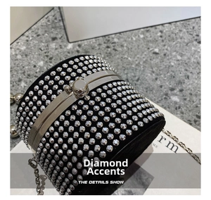 Detail of a sparkling rhinestone cylinder evening bag with silver sphere clasp and chain