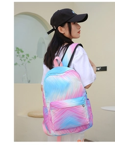 Side view of a blue and pink gradient tie-dye casual backpack worn by a model