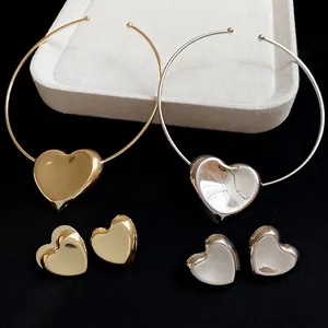 Gold and silver heart jewelry set with polished chokers and matching stud earrings