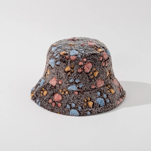 Close-up of plush bucket hat featuring colorful cat paw prints on soft grey faux fur