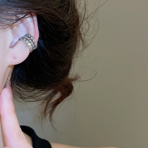 Detail of silver multi-layer ear cuff with zircons, clip-on earring for non-pierced ears